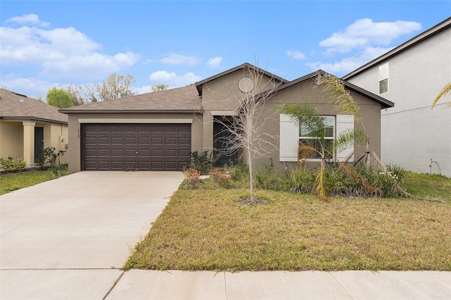 single story home featuring a front lawn, driveway, an attached garage, and stucco siding