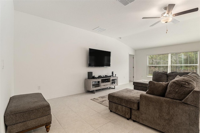 living area with lofted ceiling, ceiling fan, light tile patterned floors, and visible vents