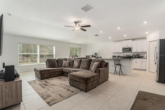 living room with light tile patterned floors, visible vents, a ceiling fan, and recessed lighting