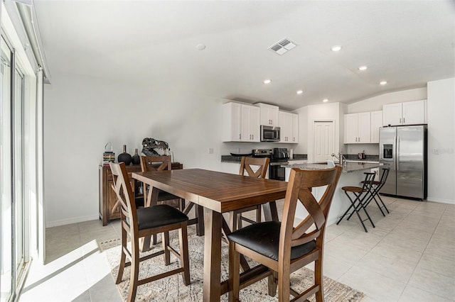 dining space featuring light tile patterned floors, baseboards, visible vents, lofted ceiling, and recessed lighting