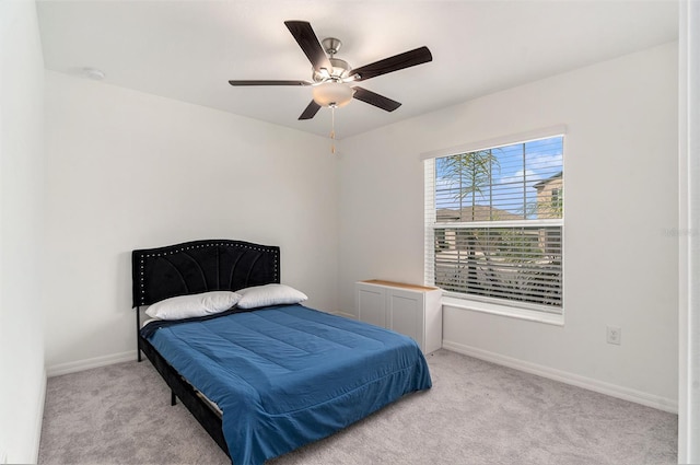 bedroom featuring ceiling fan, carpet flooring, and baseboards