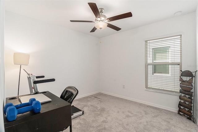 office area with carpet flooring, a ceiling fan, and baseboards