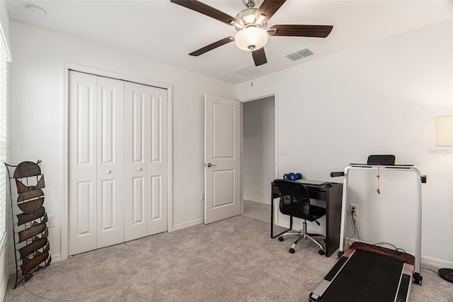 office area featuring light carpet, baseboards, visible vents, and a ceiling fan