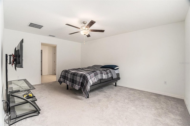 bedroom featuring light colored carpet, visible vents, ceiling fan, and baseboards