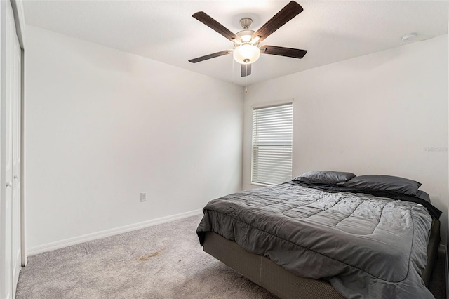 carpeted bedroom featuring ceiling fan and baseboards