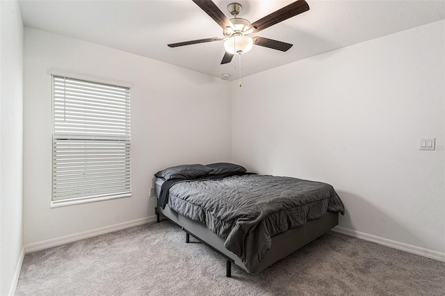 bedroom with light colored carpet, ceiling fan, and baseboards