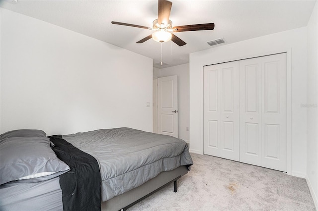 bedroom with carpet floors, a closet, visible vents, a ceiling fan, and baseboards