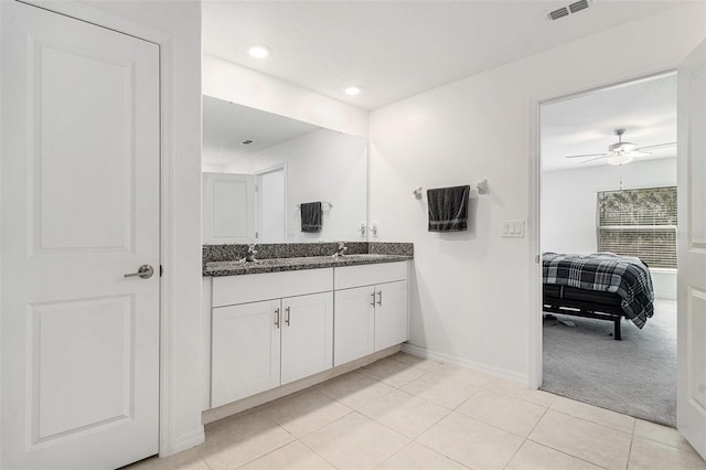 full bathroom with double vanity, tile patterned flooring, visible vents, and a sink