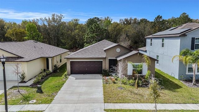 view of front of property featuring driveway, stucco siding, an attached garage, and a front yard