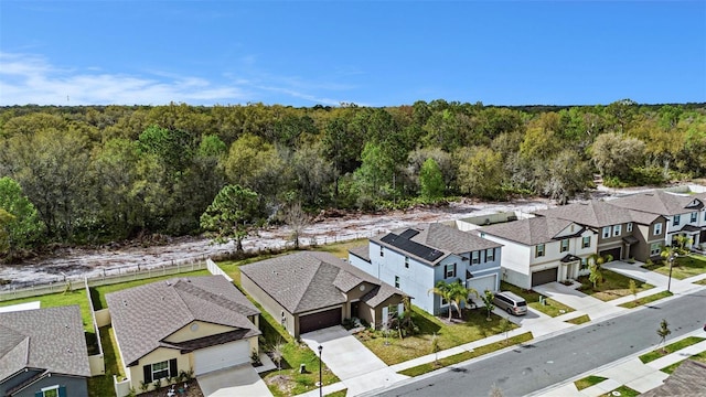 birds eye view of property with a residential view and a view of trees