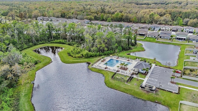 aerial view with a forest view, a water view, and a residential view