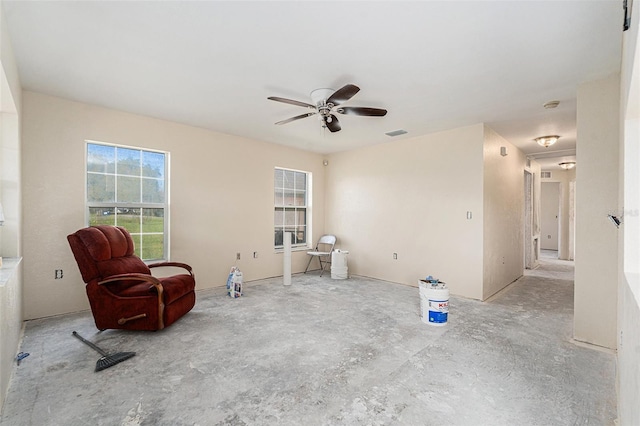 living area featuring ceiling fan and visible vents