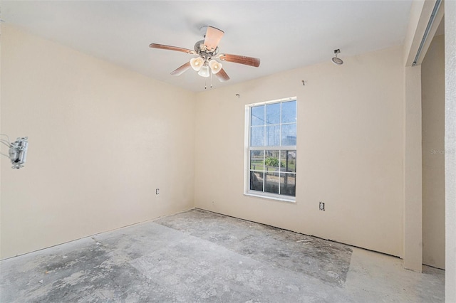 empty room with concrete floors and a ceiling fan