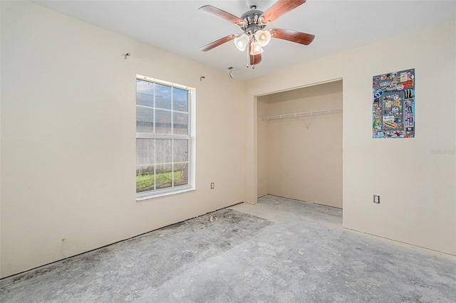 unfurnished bedroom with ceiling fan, concrete floors, and a closet