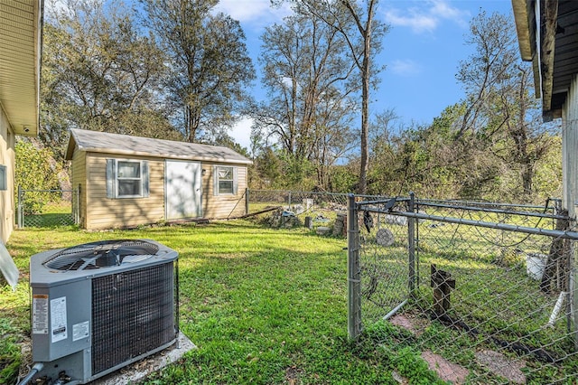 view of yard with an outdoor structure, a fenced backyard, a gate, and central air condition unit