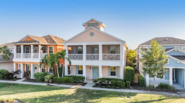 view of front of property featuring a sunroom, stucco siding, and a front yard