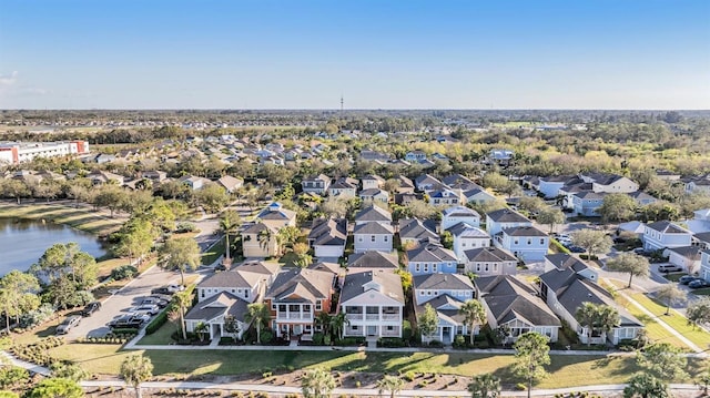 drone / aerial view with a water view and a residential view