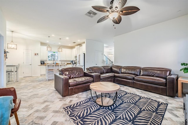 living area with stairway, visible vents, a ceiling fan, and recessed lighting