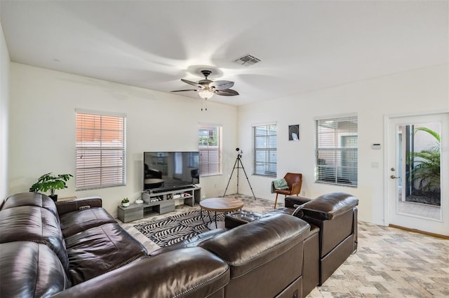 living area featuring visible vents and a ceiling fan