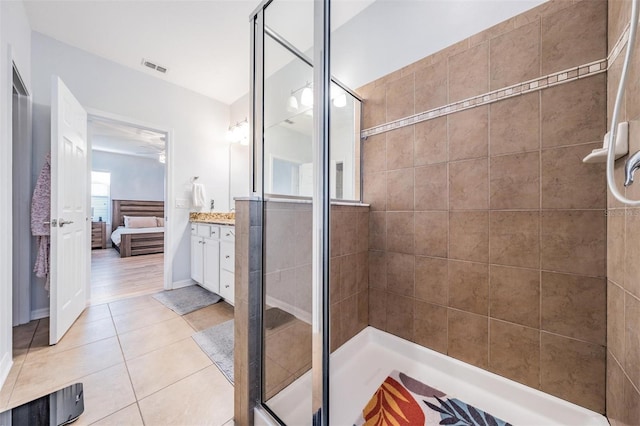 ensuite bathroom with visible vents, a stall shower, vanity, ensuite bath, and tile patterned floors