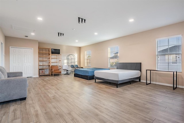 bedroom with recessed lighting, baseboards, and wood finished floors