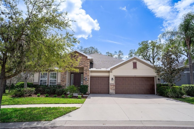 ranch-style home featuring driveway, stone siding, roof with shingles, an attached garage, and stucco siding