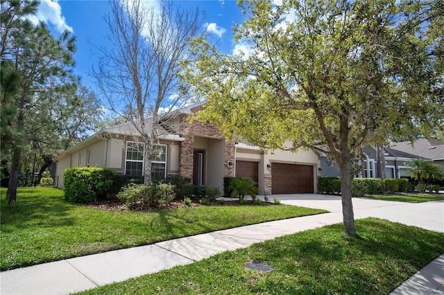 view of front of home with an attached garage, stone siding, driveway, stucco siding, and a front yard