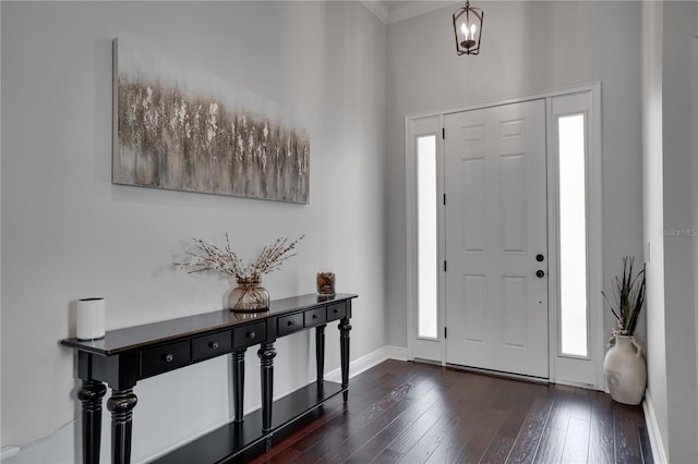 entrance foyer with dark wood-style floors and baseboards