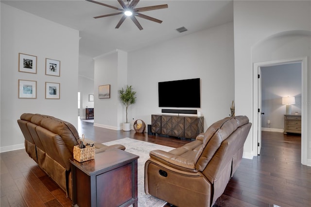 living area featuring baseboards, visible vents, and dark wood-type flooring