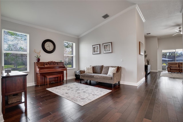 living area with crown molding, dark wood finished floors, and baseboards