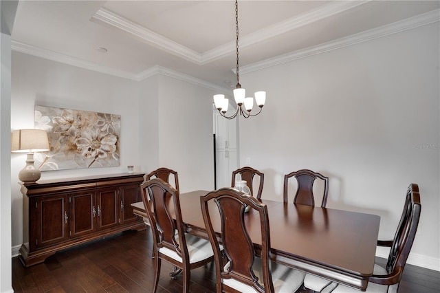 dining room with a tray ceiling, ornamental molding, a chandelier, and dark wood-type flooring