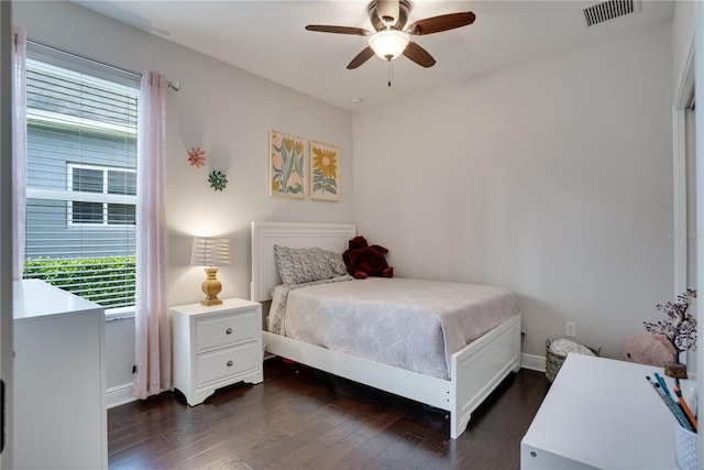 bedroom featuring a ceiling fan, baseboards, visible vents, and dark wood-style flooring