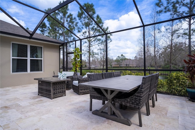 view of patio with a lanai and fence