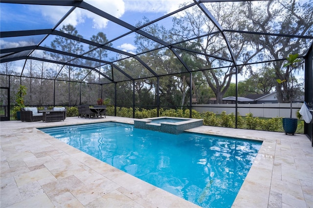 view of swimming pool with a patio area, a pool with connected hot tub, glass enclosure, and an outdoor hangout area