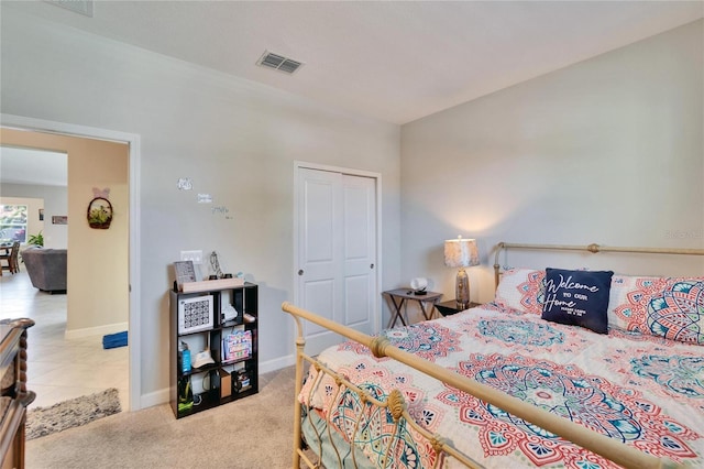carpeted bedroom with visible vents and baseboards