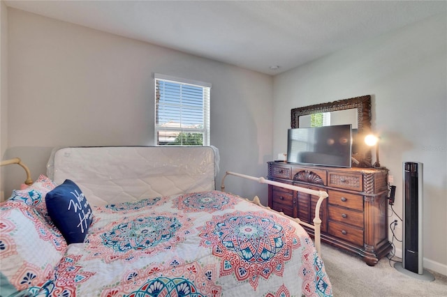 bedroom with baseboards and carpet