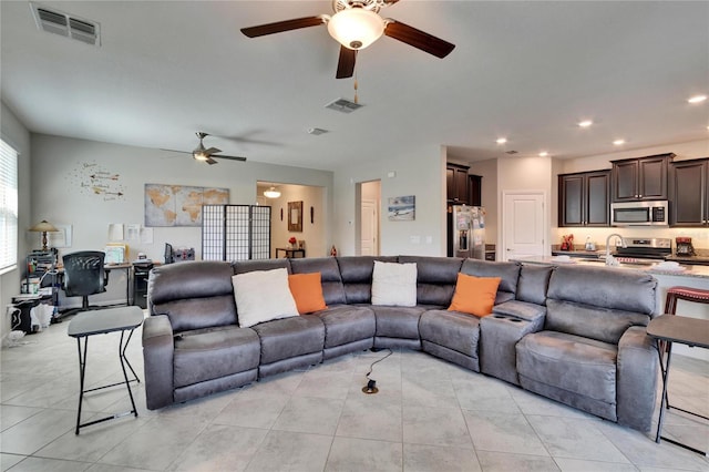 living area featuring recessed lighting, visible vents, light tile patterned flooring, and a ceiling fan