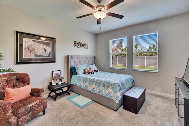 bedroom with baseboards, light colored carpet, and ceiling fan