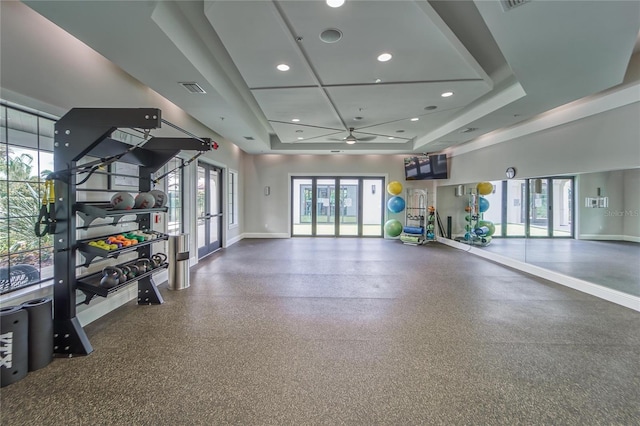 exercise room with visible vents, a ceiling fan, baseboards, french doors, and a raised ceiling