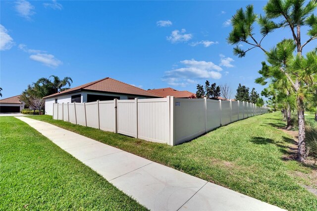 view of home's exterior featuring a yard and fence