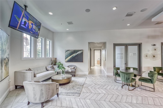 living area featuring recessed lighting, visible vents, and baseboards