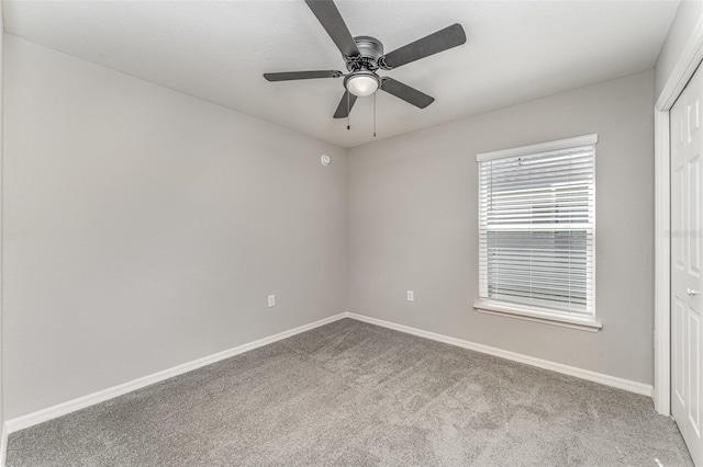 unfurnished bedroom with a ceiling fan, carpet, a closet, and baseboards