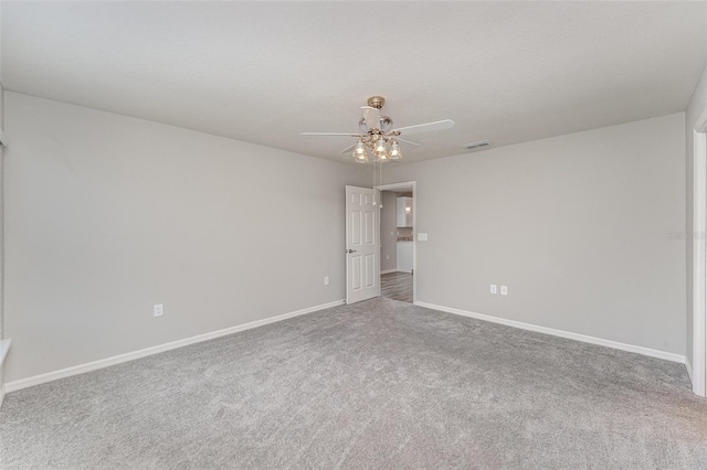 spare room featuring ceiling fan, a textured ceiling, carpet floors, visible vents, and baseboards