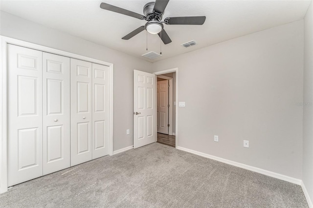 unfurnished bedroom featuring visible vents, baseboards, ceiling fan, carpet flooring, and a closet