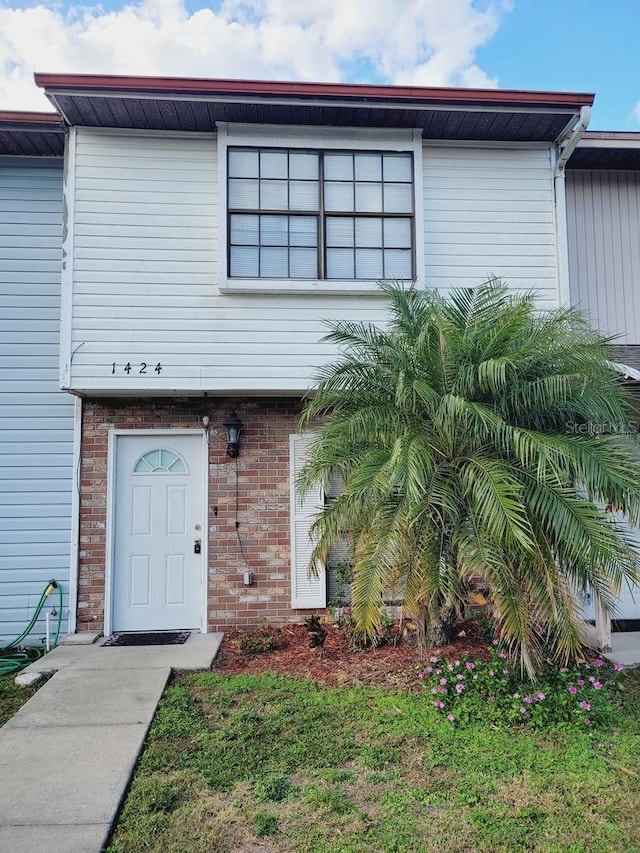 view of property featuring brick siding