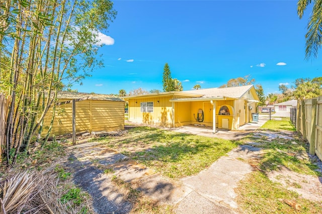 rear view of property featuring fence