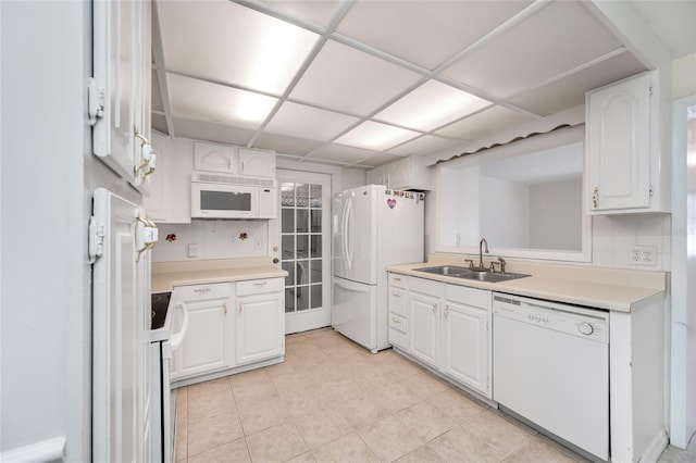 kitchen featuring light countertops, white appliances, a sink, and white cabinets