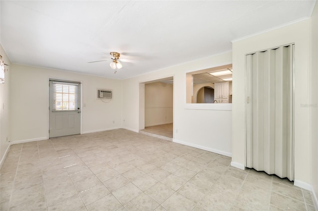 empty room featuring a wall mounted air conditioner, ceiling fan, baseboards, and light tile patterned floors