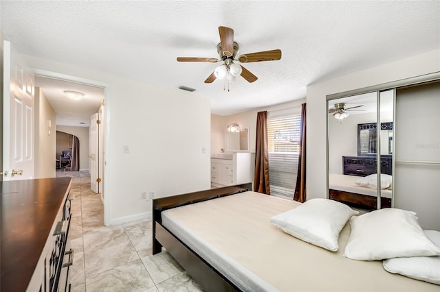 bedroom featuring arched walkways, marble finish floor, a closet, visible vents, and a textured ceiling