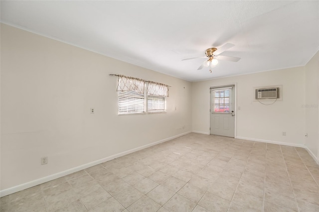 spare room with a wall mounted AC, a ceiling fan, and baseboards